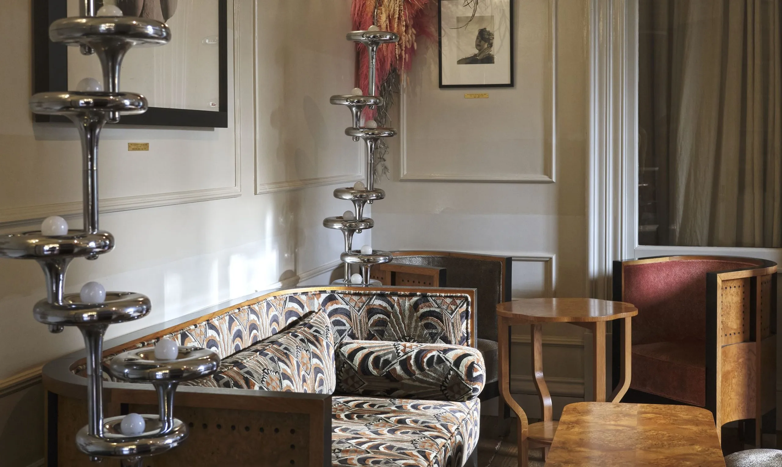 Bertie's Whisky Bar at The Fife Arms, its shelves lined with hundreds of whisky bottles lit by amber lamps