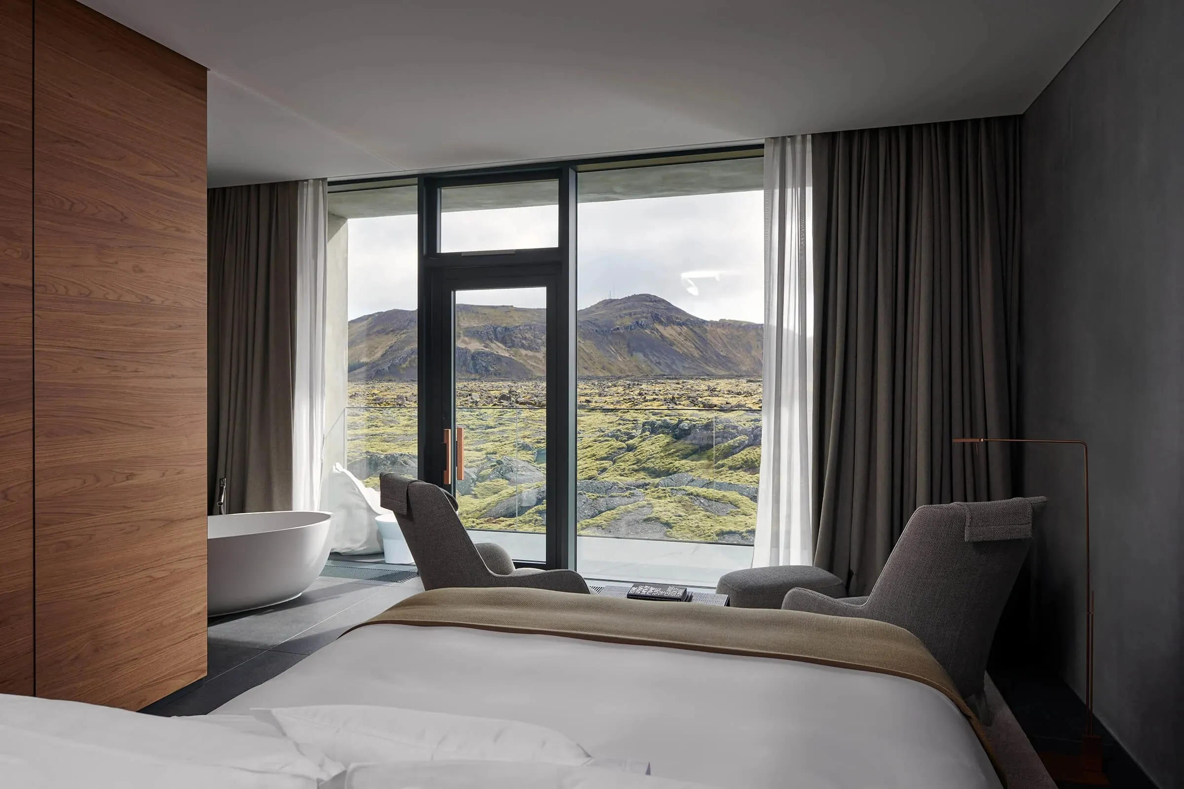 A Lagoon Suite interior with floor-to-ceiling windows overlooking the private lagoon