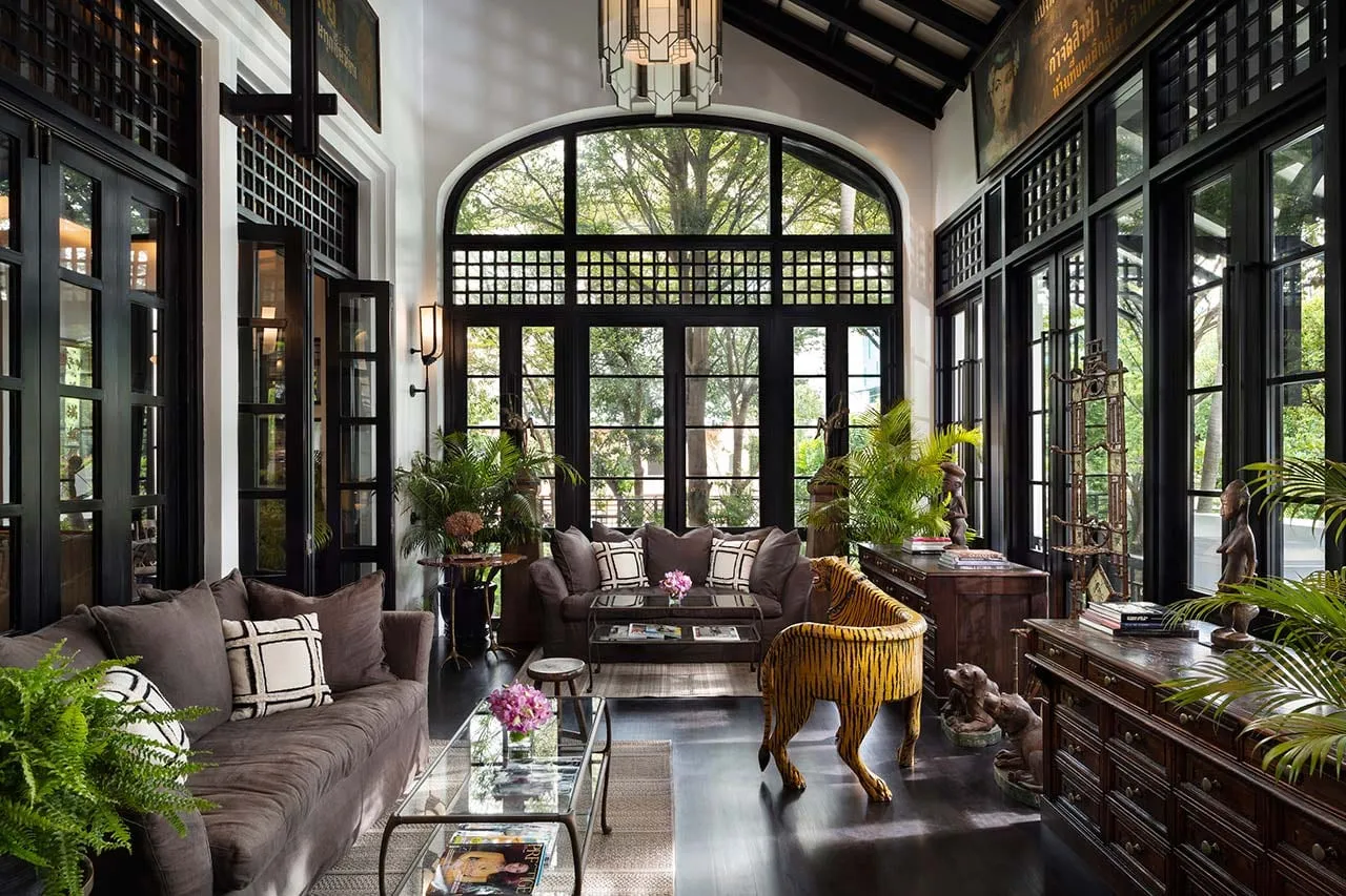 An antique-filled interior lounge at The Siam hotel in Bangkok