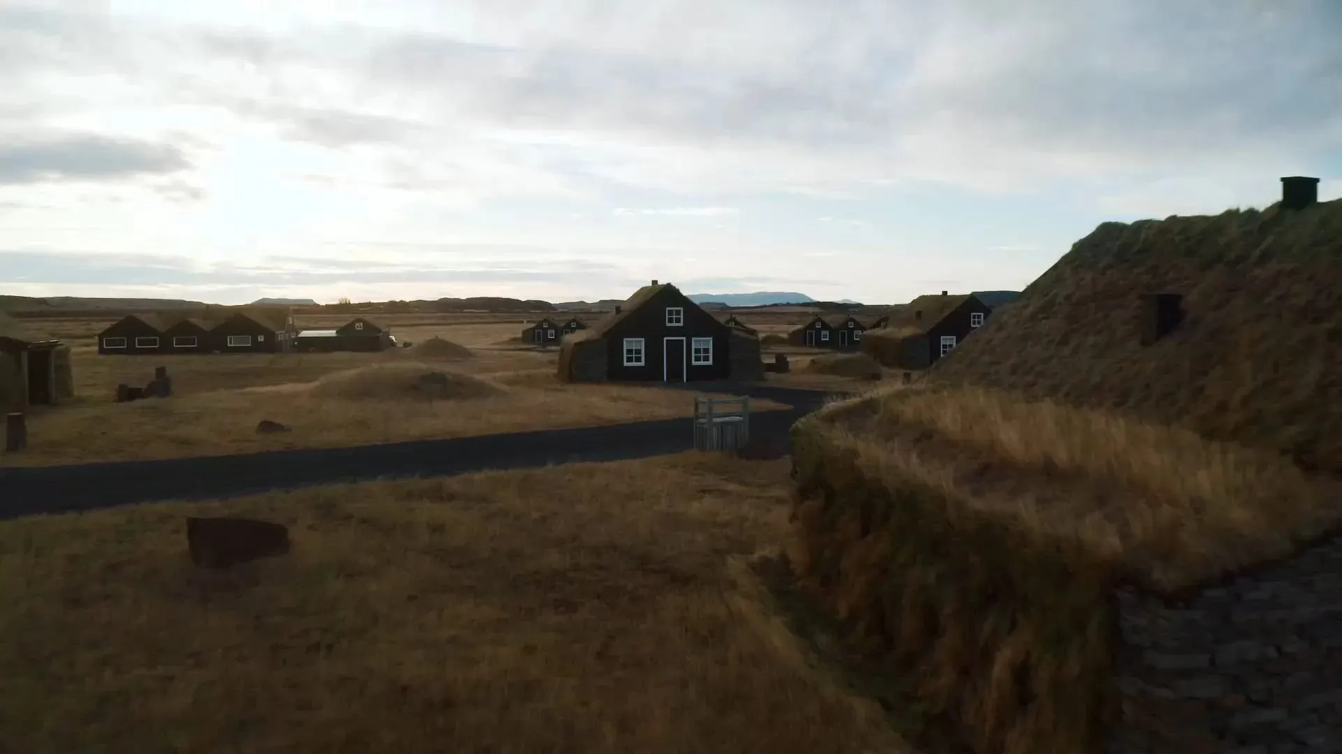 Turf-roofed suites at Torfhus Retreat set into the meadow landscape of Iceland's Golden Circle