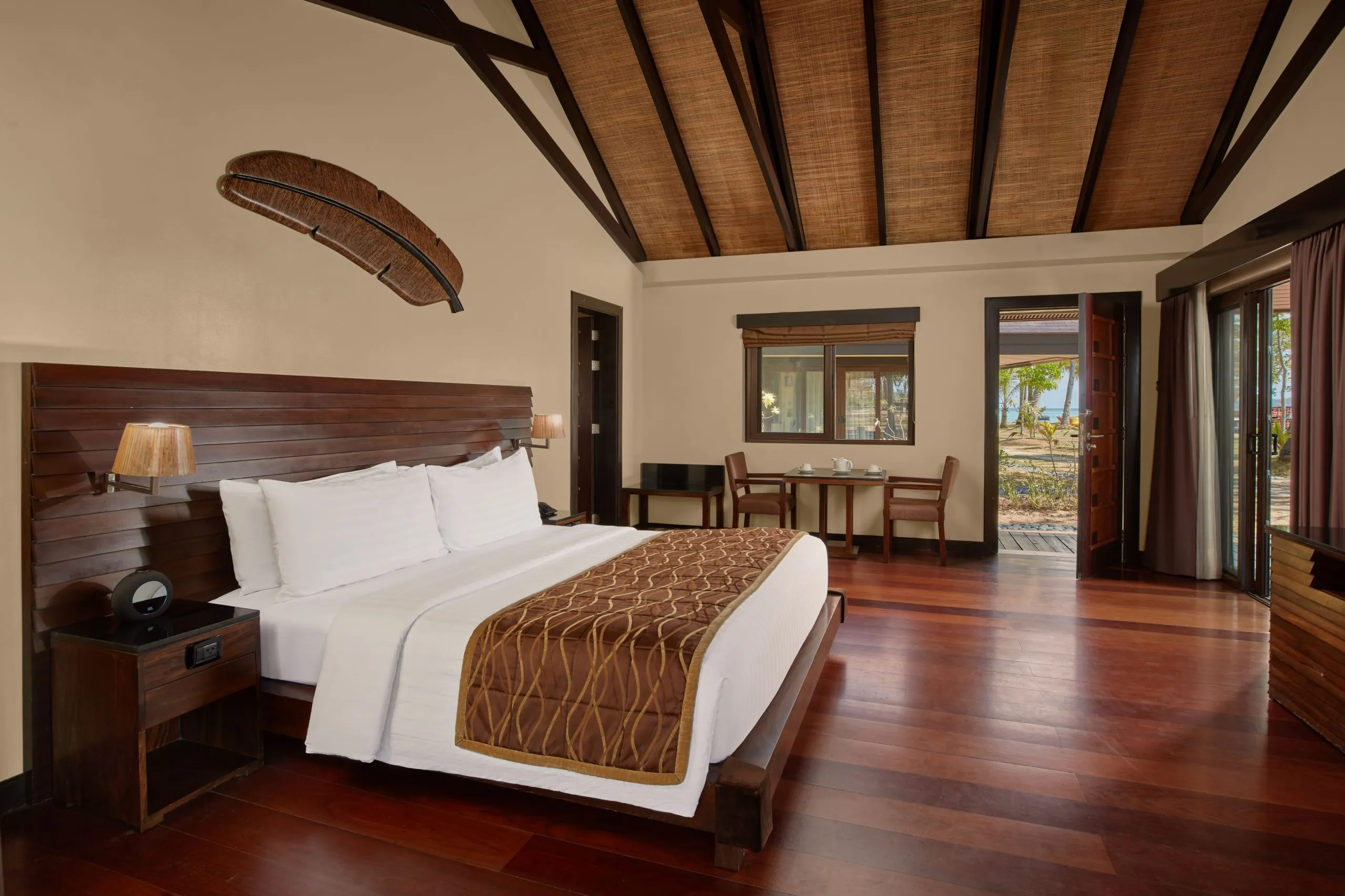 A high-ceilinged Filipino-tropical bungalow at Two Seasons Coron set among tropical garden planting