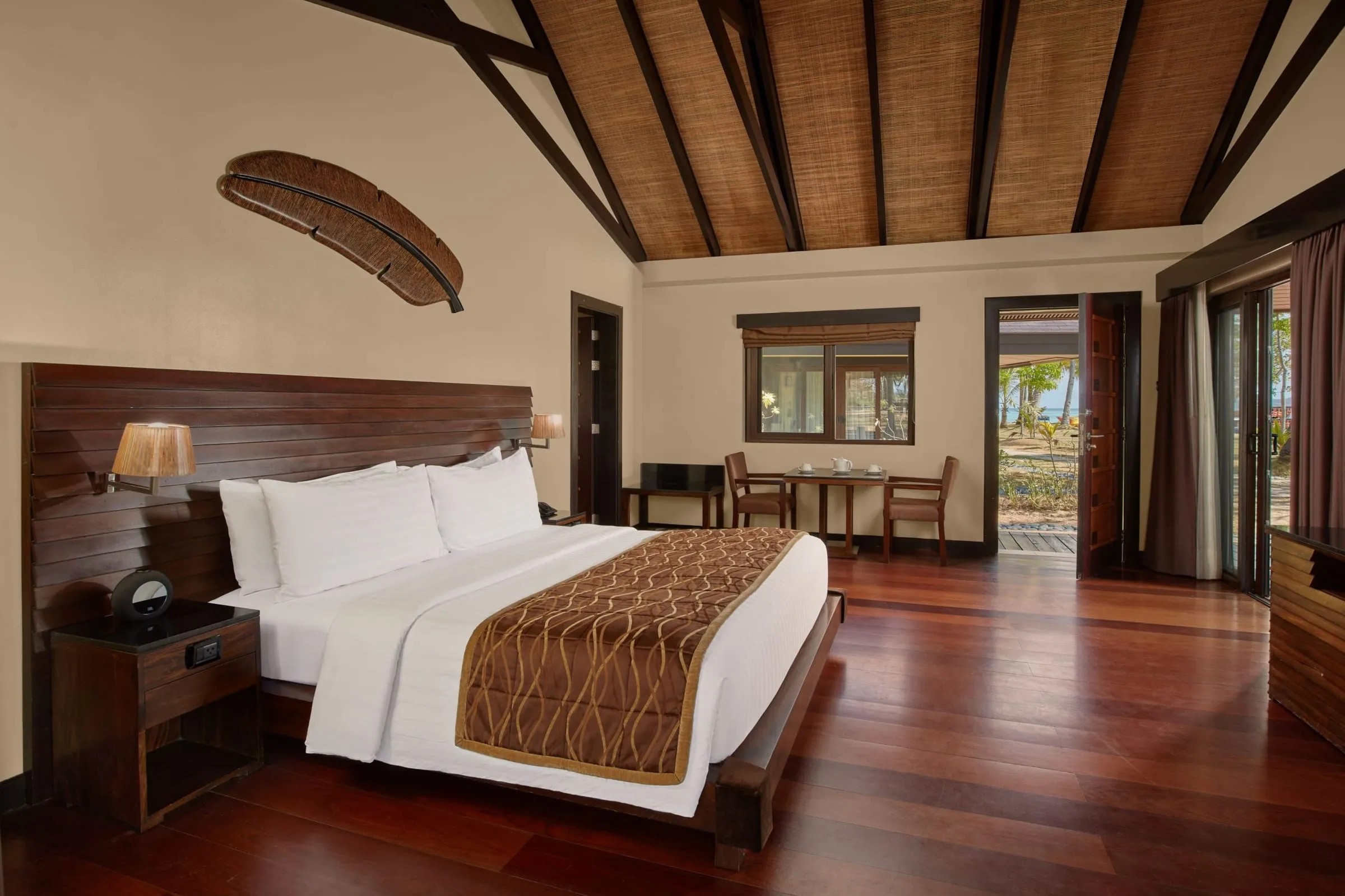 A high-ceilinged Filipino-tropical bungalow at Two Seasons Coron set among tropical garden planting