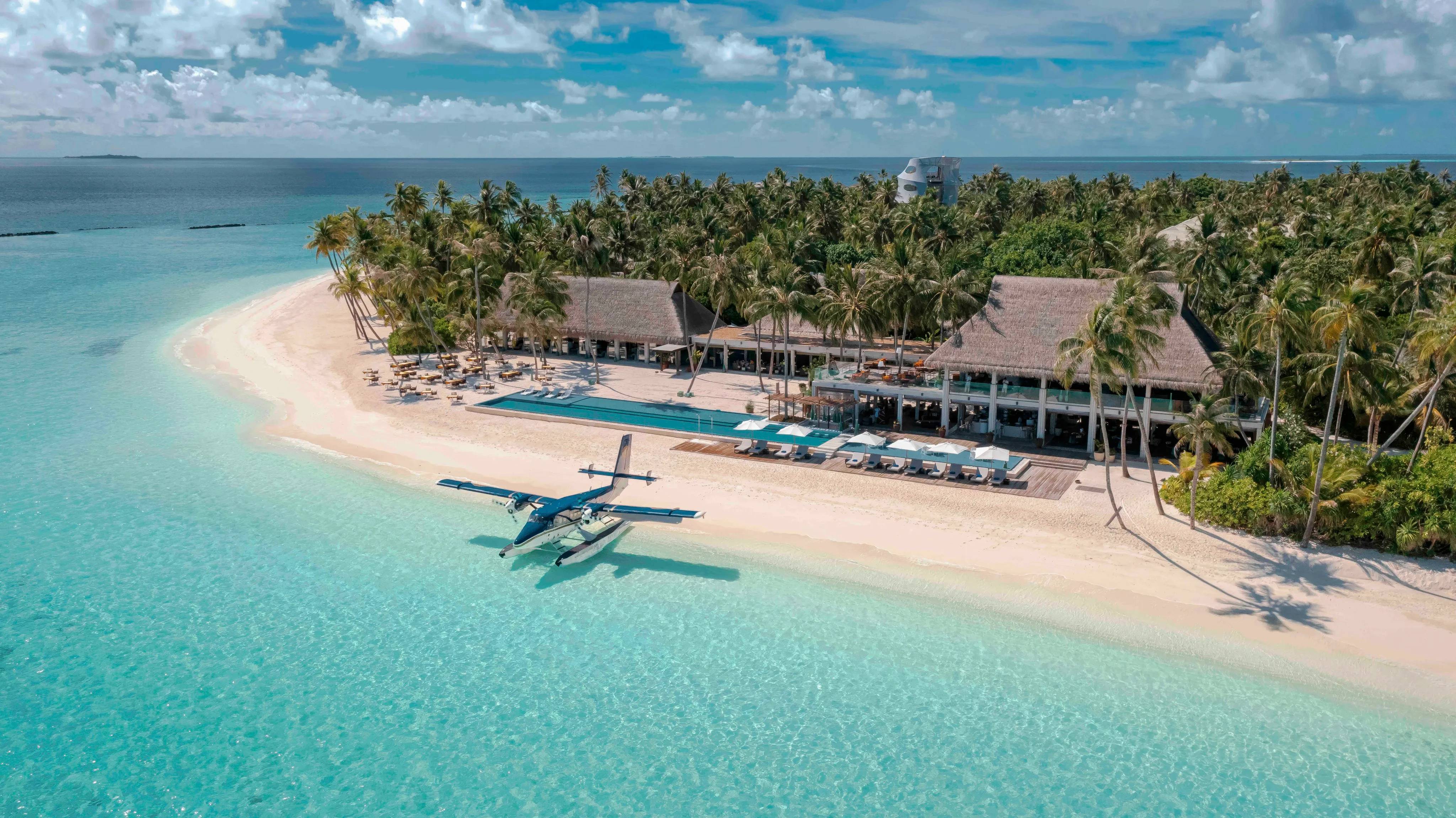 Clear turquoise water and a sandbank at Velaa Private Island, Noonu Atoll, seen from above