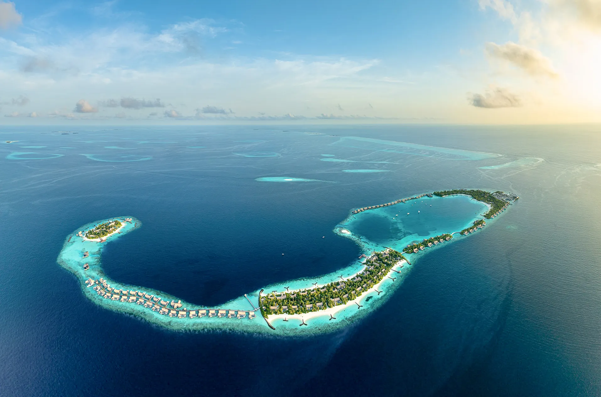 An overwater spa treatment pavilion with glass floor panels looking down into the lagoon