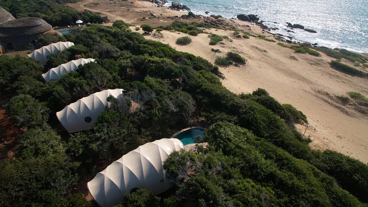 Cocoon-shaped tented suites of Wild Coast Tented Lodge set among boulders on the edge of Yala National Park, Sri Lanka
